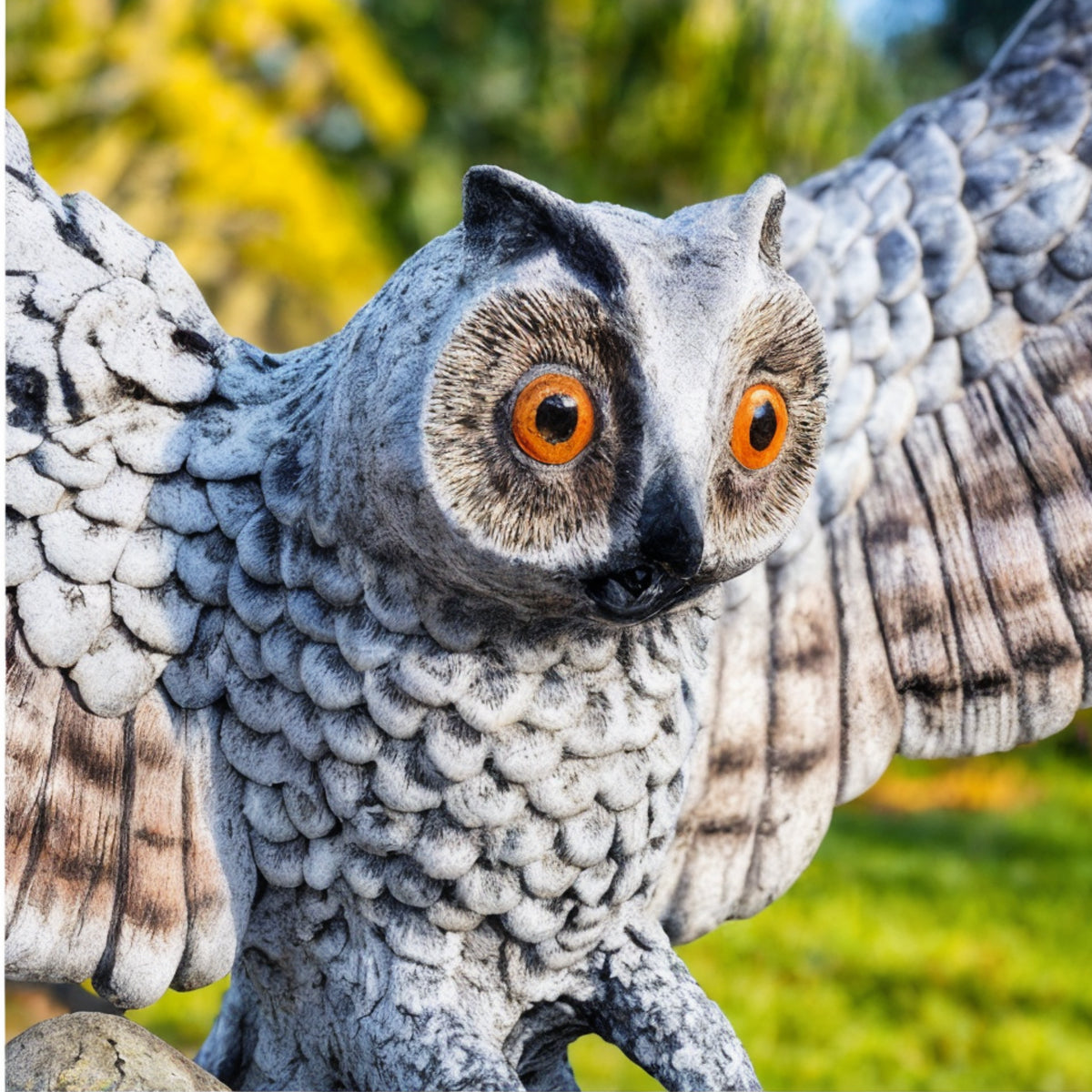 Close-up of hand-painted owl face with orange eyes on mailbox sculpture