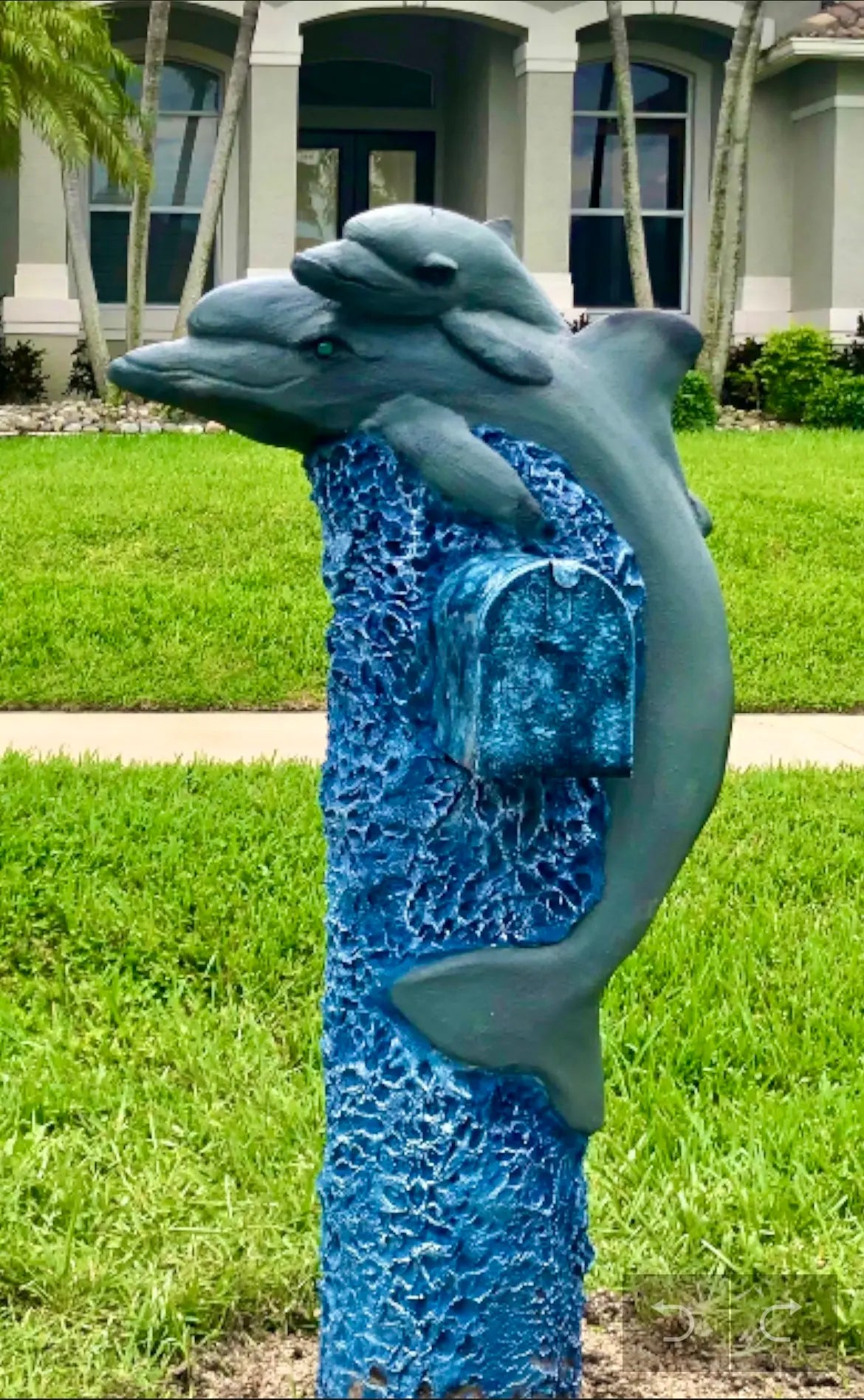 Handcrafted dolphin statue, mother by Seaside Mailbox, nautical cement art for coastal homes.
