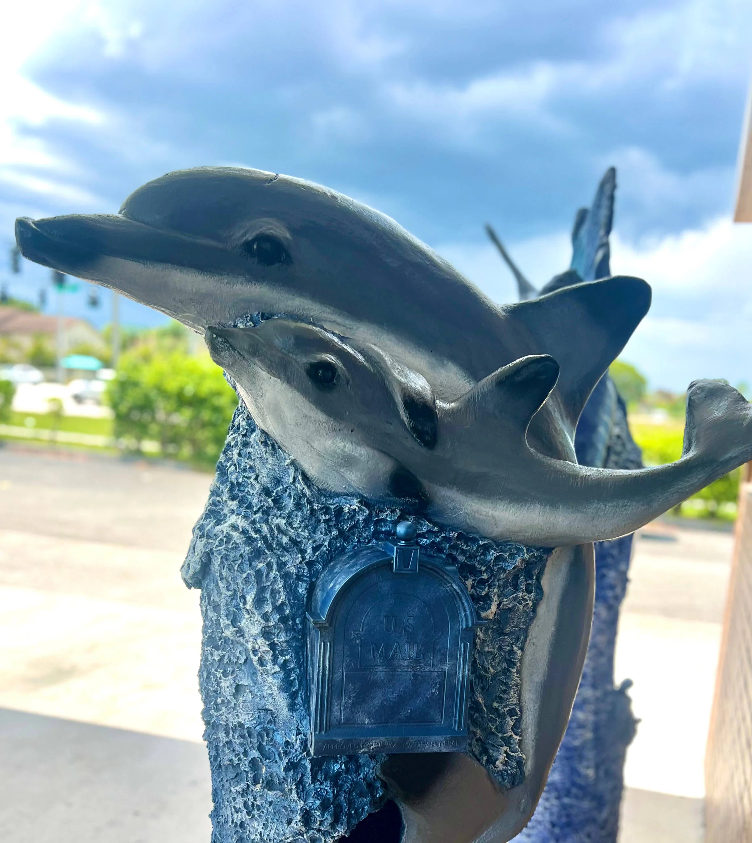 Handcrafted dolphin statue, mother by Seaside Mailbox, nautical cement art for coastal homes.