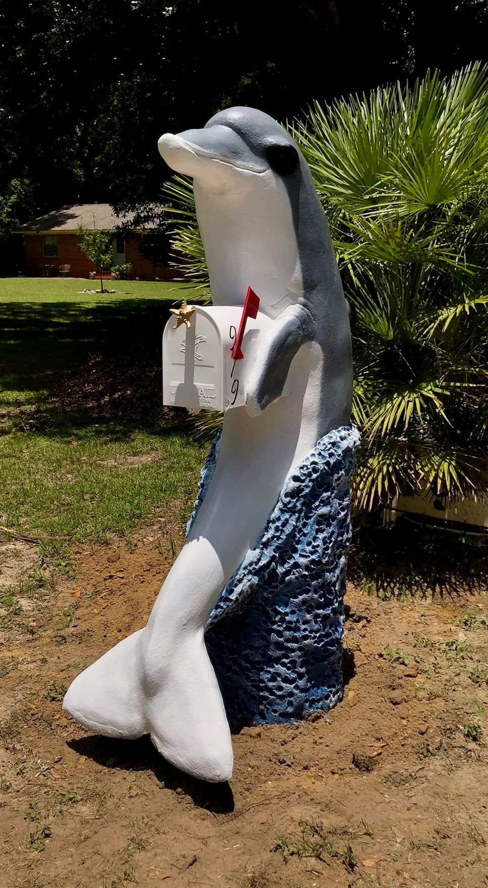 Handcrafted gray dolphin statue, white mailbox by Seaside Mailbox, nautical cement art for coastal homes.
