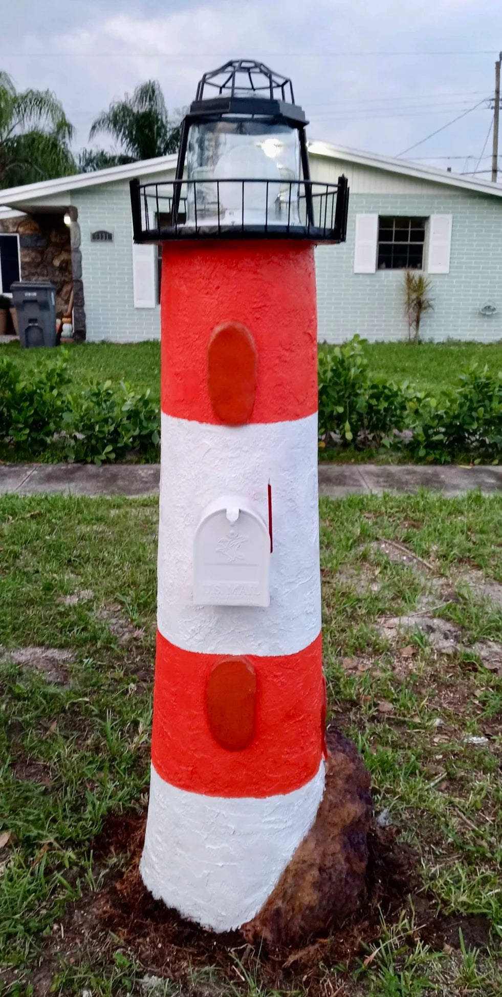 Handcrafted lighthouse mailbox, red white stripes by Seaside Mailbox, nautical cement art for coastal homes.