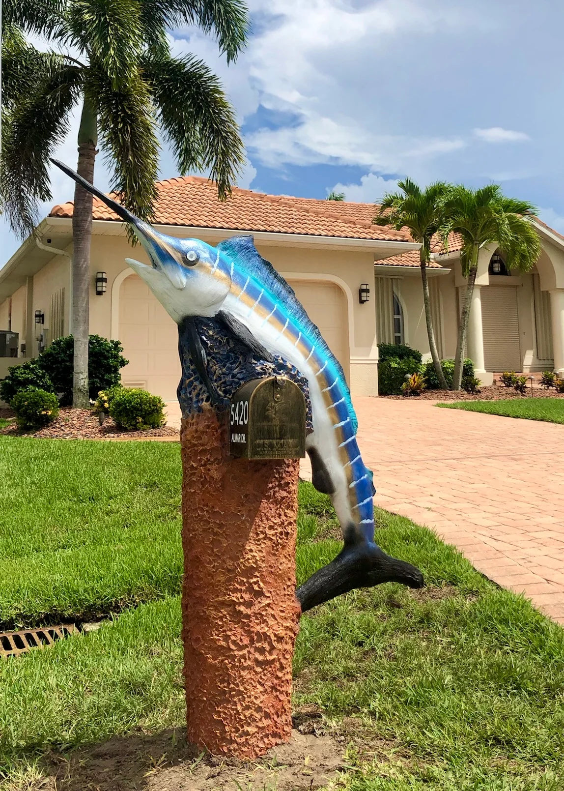 Handcrafted blue marlin statue, iridescent gold stripes by Seaside Mailbox, nautical cement art for coastal homes.