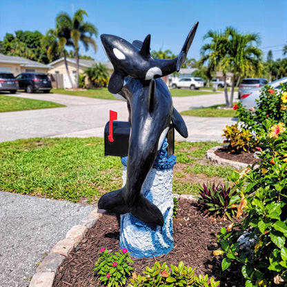 Side view of killer whale orca mailbox sculpture in a front yard
